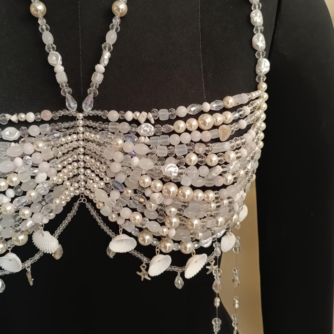 Close up of pearl and crystal beaded bralette necklace showing intricate hand-strung details and shell charm accents