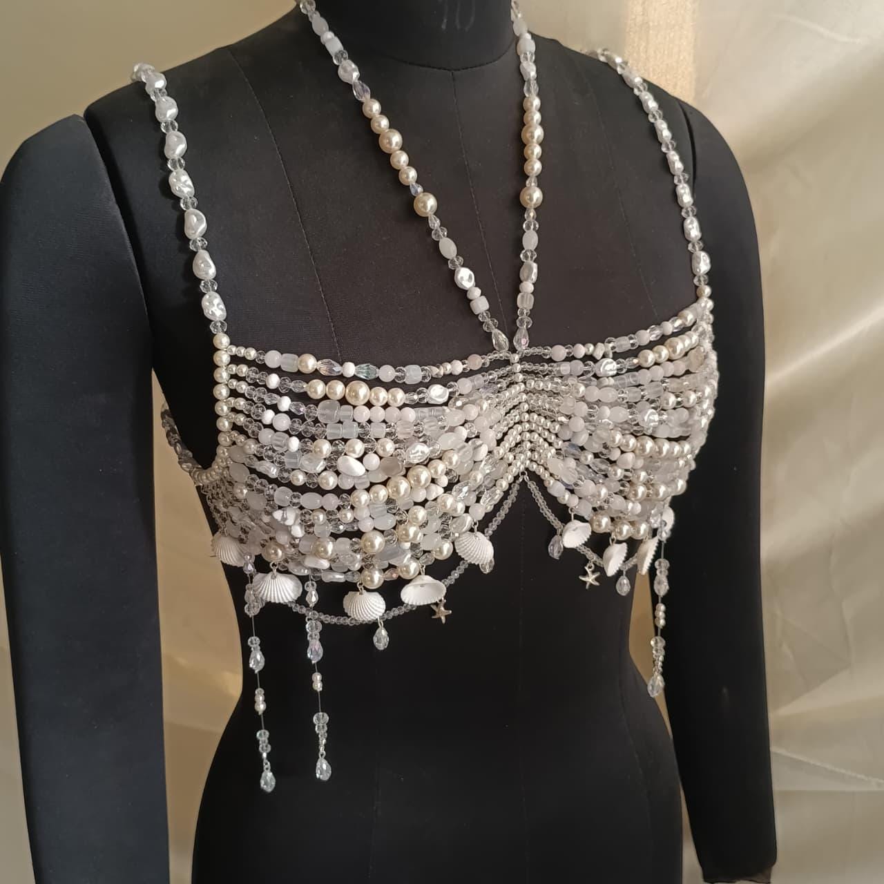 Handmade pearl beaded bralette necklace with crystals and shell charms displayed on black mannequin, mermaid inspired bridal body jewelry