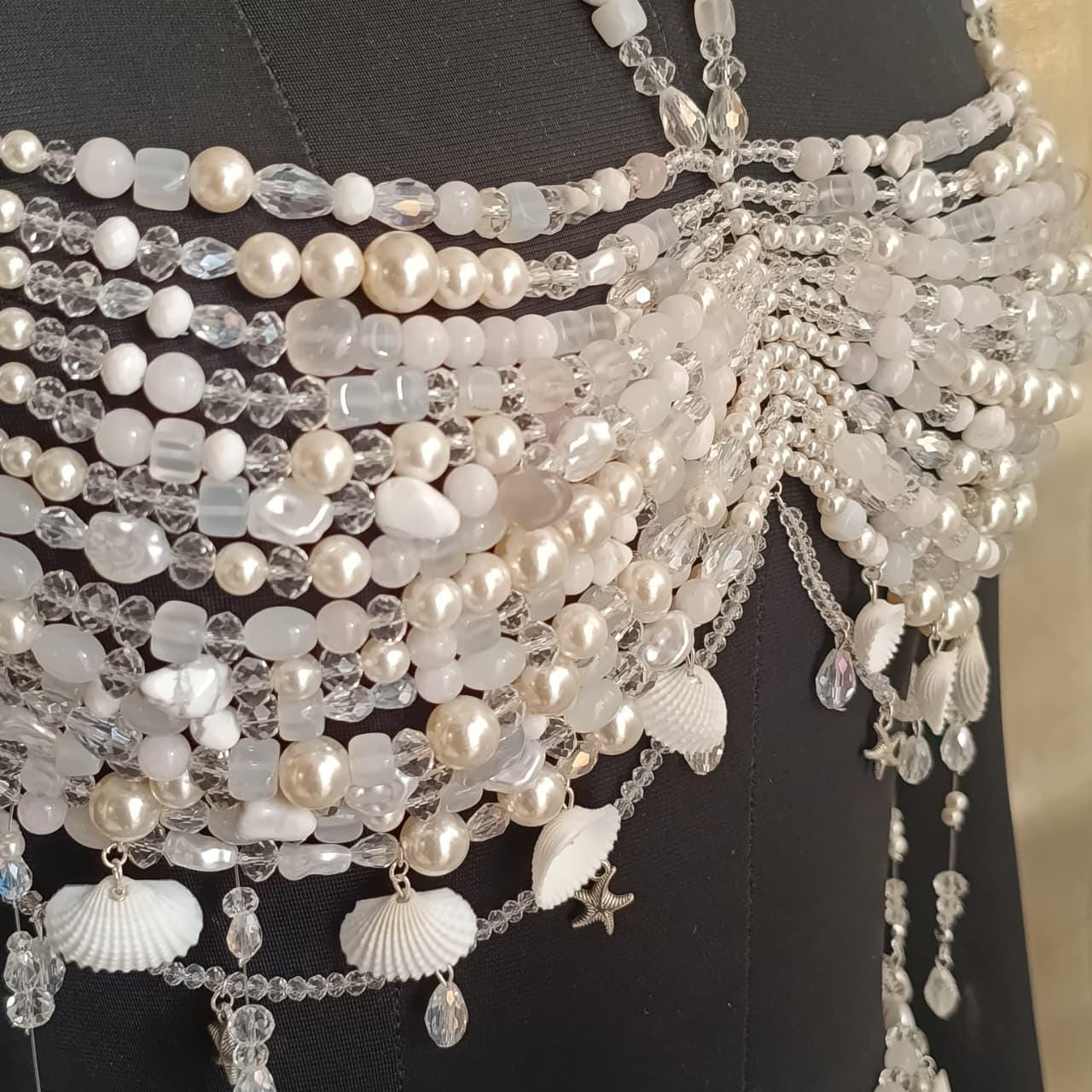 Macro shot of mixed pearl, crystal and glass beads used in handmade bralette necklace body jewelry