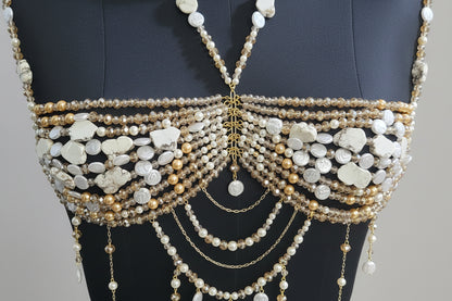Closeup of golden crystal and white pearls showing handmade craftsmanship of pearl bralette