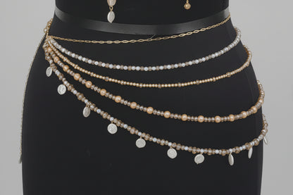 Mannequin wearing a pearl and gold crystal chain belt with matching bralette